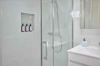 a white bathroom with a shower and a sink at Jasmine Whisper by Elysian in Funchal
