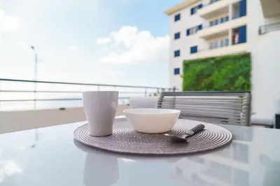 a plate with two cups on a table on a balcony at GuestReady - Relaxing moment in Caniço in Caniço