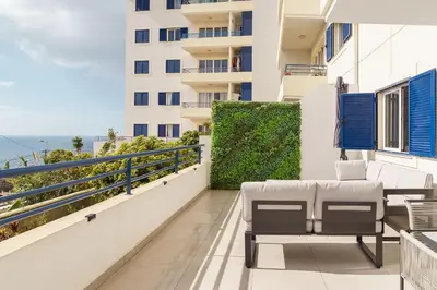 a balcony with chairs and a view of the ocean at GuestReady - Relaxing moment in Caniço in Caniço