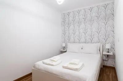 a bedroom with a white bed with two towels on it at GuestReady - Relaxing moment in Caniço in Caniço