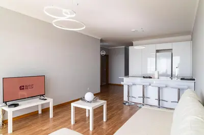 a living room with a couch and a tv at GuestReady - Relaxing moment in Caniço in Caniço