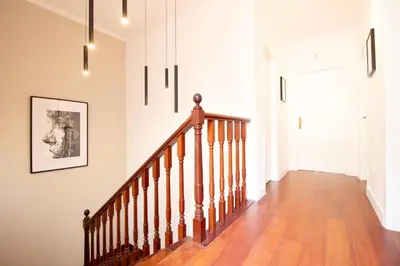 a staircase in a home with white walls and wood floors at Funchal Terrace House in Funchal