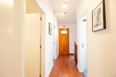 a hallway with a brown door and white walls at Funchal Terrace House in Funchal