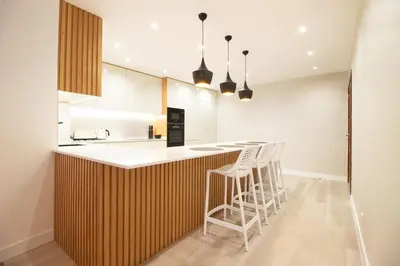 a kitchen with a counter with stools in it at Funchal Terrace House in Funchal