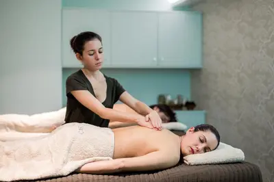 a woman giving a man a massage on a bed at Castanheiro Boutique Hotel in Funchal