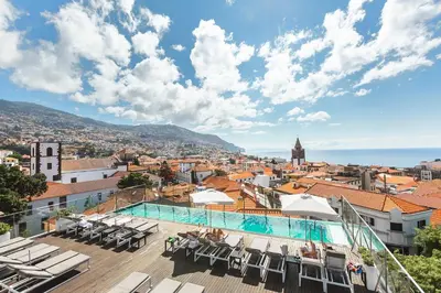 a view from the rooftop of a hotel with a swimming pool at Castanheiro Boutique Hotel in Funchal