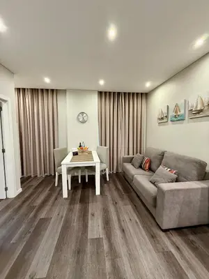 a living room with a couch and a table at Gold Center Funchal 104 in Funchal