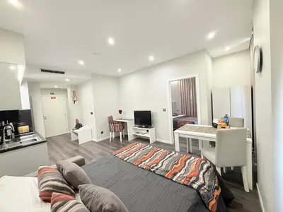 a bedroom with a bed and a kitchen with a desk at Gold Center Funchal 104 in Funchal