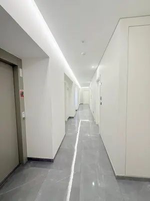 an empty hallway in a building with white walls at Gold Center Funchal 104 in Funchal