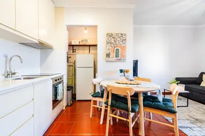 a kitchen and dining room with a table and chairs at GuestReady - Madeiran peaceful nook in Porto Moniz