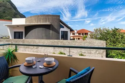 a table on the balcony of a house at GuestReady - Madeiran peaceful nook in Porto Moniz