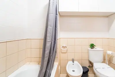 a bathroom with a toilet and a tub and a sink at GuestReady - Madeiran peaceful nook in Porto Moniz