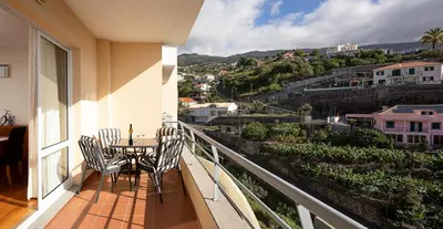 a balcony with a table and chairs and a view at Calheta, Sun, Sea & Pool in Calheta