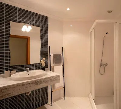 a bathroom with a sink and a mirror and a shower at Calheta, Sun, Sea & Pool in Calheta