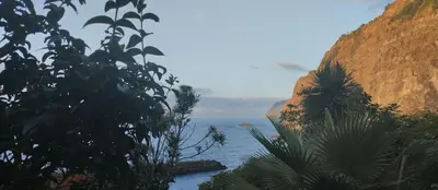 a view of the ocean from the side of a cliff at Dhamma Guest House in Ponta Delgada
