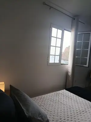 a bedroom with a bed and a window at Dhamma Guest House in Ponta Delgada