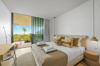 a bedroom with a bed with a desk and a balcony at Savoy Luxury Residence Apartment in Funchal