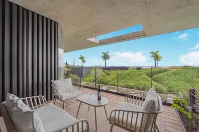 a patio with chairs and a table and a view of the ocean at Savoy Luxury Residence Apartment in Funchal