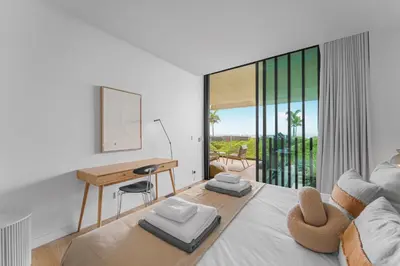 a bedroom with a large bed with a desk and a desk at Savoy Luxury Residence Apartment in Funchal