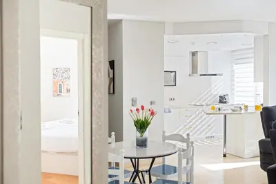 a kitchen and living room with a table and chairs at Fórum Glam 5B by Homie in Funchal
