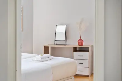 a bedroom with a bed with a mirror and a dresser at Fórum Glam 5B by Homie in Funchal