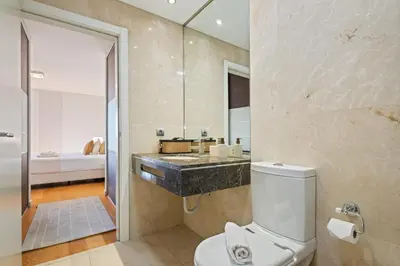 a bathroom with a toilet and a sink and a shower at Fórum Glam 5B by Homie in Funchal