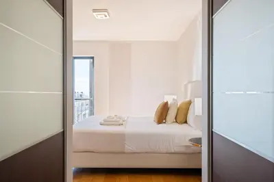 a bedroom with a bed and a glass door at Fórum Glam 5B by Homie in Funchal