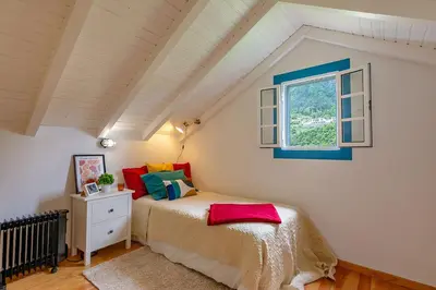 a bedroom with a bed and a window at The Yellow Cottage Nature House São Vicente Madeira Island in São Vicente