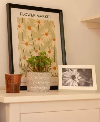 a picture and a flower market picture on a shelf at The Yellow Cottage Nature House São Vicente Madeira Island in São Vicente