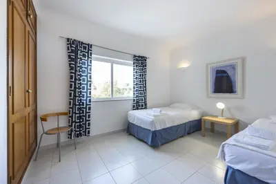 a bedroom with two beds and a window at CoolHouses Algarve Luz, Ramalhete in Luz