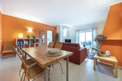 a living room with a table and a couch at CoolHouses Algarve Luz, Ramalhete in Luz
