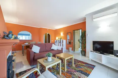 a living room with a couch and a tv at CoolHouses Algarve Luz, Ramalhete in Luz