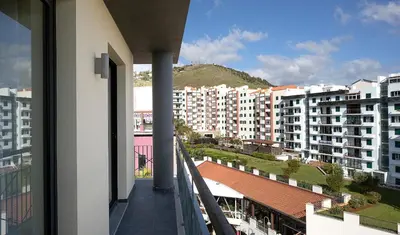 a balcony with a view of a city with buildings at JOY Forum I in Funchal