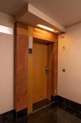 a hallway with a wooden door in a room at JOY Forum I in Funchal