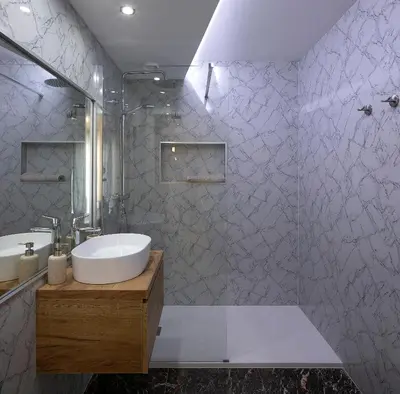 a bathroom with a white sink and a shower at JOY Forum I in Funchal