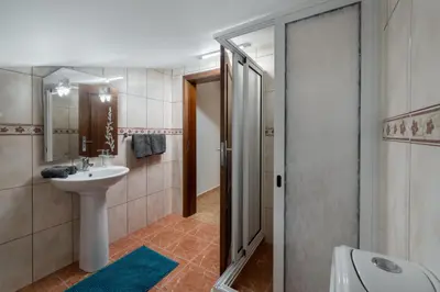 a bathroom with a sink and a toilet and a shower at OurMadeira - Ponta do Sol SeaView in Relógio do Poiso
