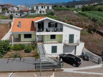 a house with a car parked in front of it at OurMadeira - Ponta do Sol SeaView in Relógio do Poiso