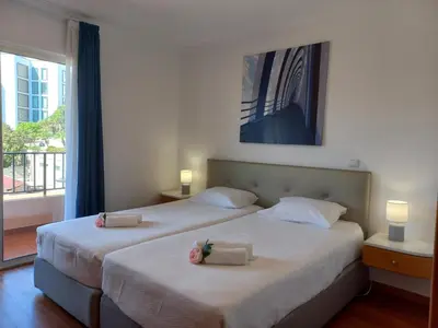 a bedroom with two beds with towels on them at Monumental Sur Mer in Funchal