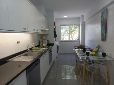 a kitchen with a sink and a table in it at Monumental Sur Mer in Funchal