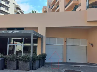 a building with two garage doors and a red triangle at Monumental Sur Mer in Funchal