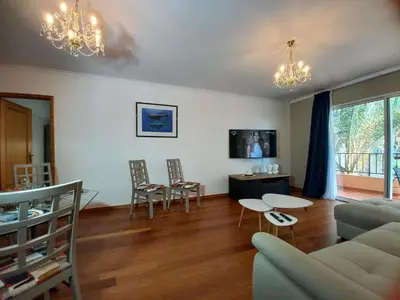 a living room with a couch and a table and chairs at Monumental Sur Mer in Funchal