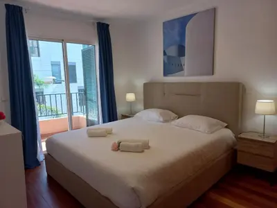 a bedroom with a large bed with two towels on it at Monumental Sur Mer in Funchal