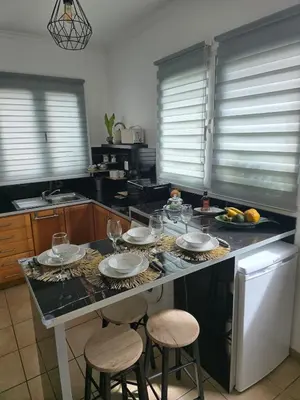 a kitchen with a table with plates and glasses on it at Casa da Cruz in Porto da Cruz