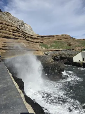 a wave hitting the side of a body of water at Casa da Cruz in Porto da Cruz