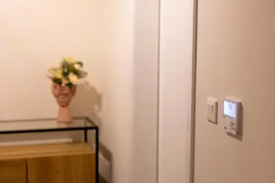 a vase of flowers sitting on a table next to a refrigerator at City Center Apartment with Parking - 2stay in Funchal