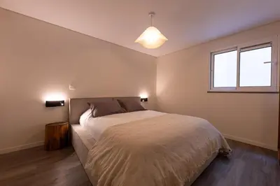 a bedroom with a large bed and a window at City Center Apartment with Parking - 2stay in Funchal