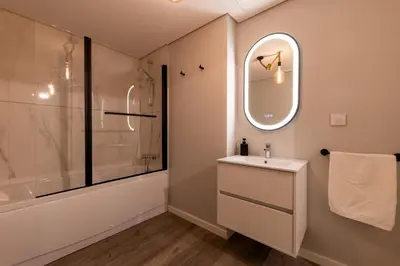 a bathroom with a sink and a shower and a mirror at City Center Apartment with Parking - 2stay in Funchal