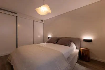 a bedroom with a bed and two lights on the wall at City Center Apartment with Parking - 2stay in Funchal