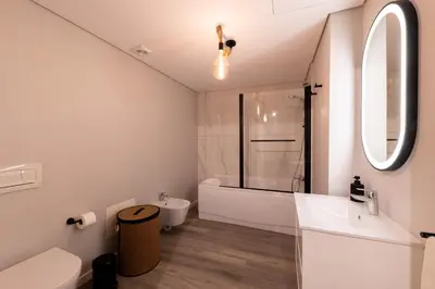 a bathroom with a sink and a toilet and a tub at City Center Apartment with Parking - 2stay in Funchal