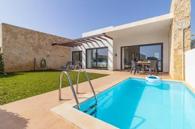 a swimming pool in the backyard of a house at Villa Infante in Sagres
